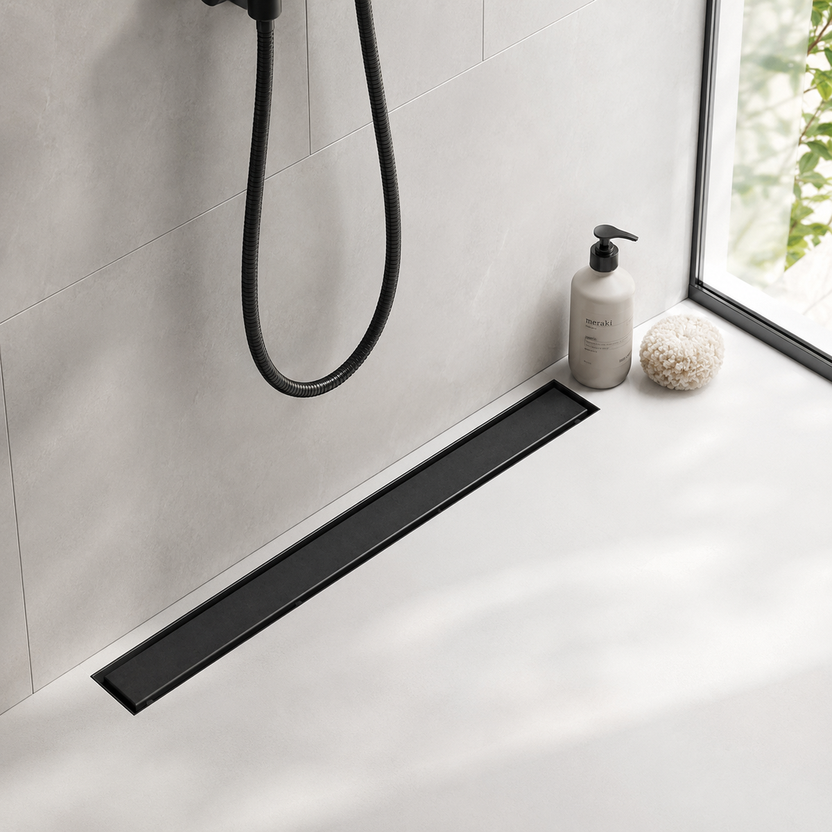 Matte black linear shower drain finish installed in a modern Canadian bathroom